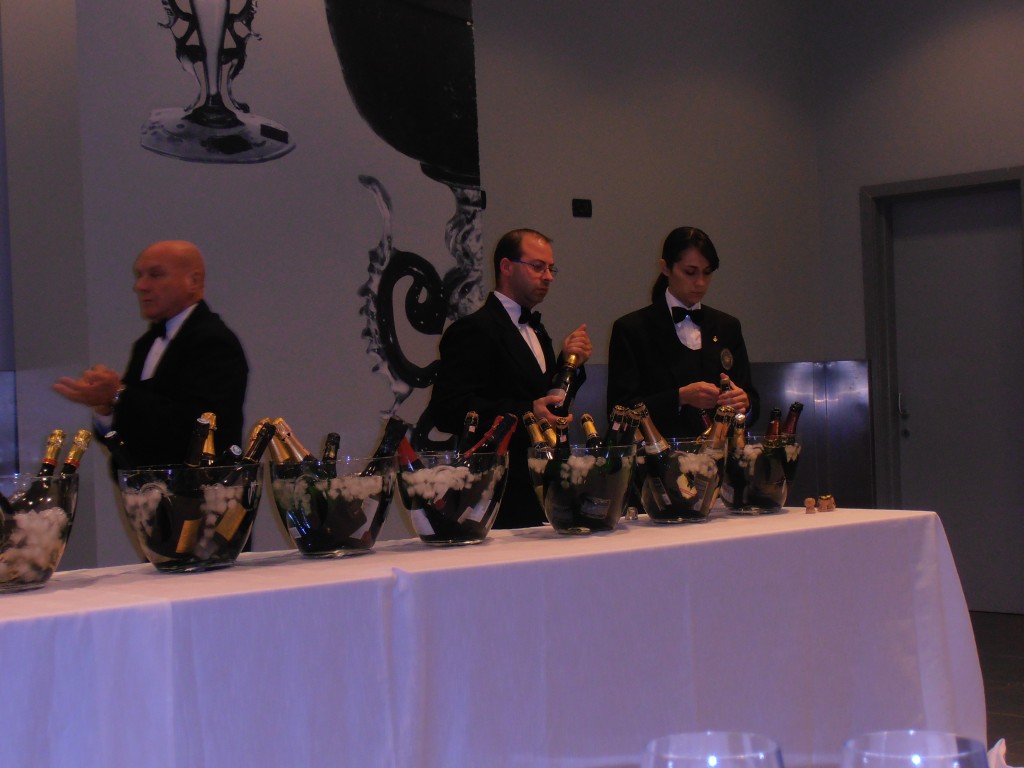 Sommeliers opening bottles at the comparative sparkling wine tasting